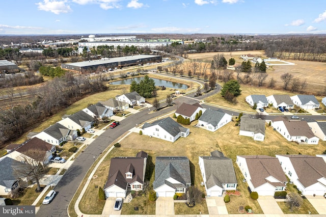 drone / aerial view featuring a residential view and a water view