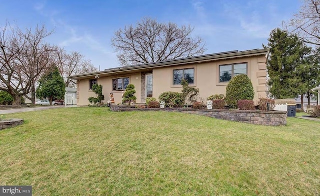 ranch-style home with stucco siding and a front yard