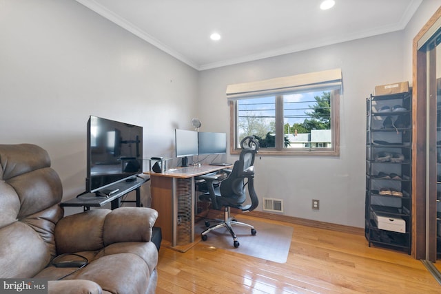 office featuring visible vents, crown molding, baseboards, recessed lighting, and light wood-style floors