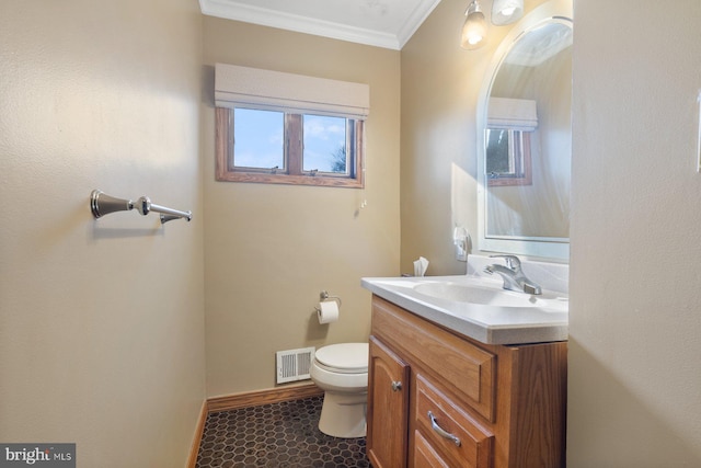 bathroom with vanity, baseboards, visible vents, crown molding, and toilet