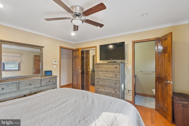 bedroom featuring baseboards, wood finished floors, and ornamental molding