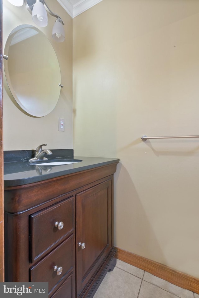 bathroom with tile patterned floors, baseboards, ornamental molding, and vanity