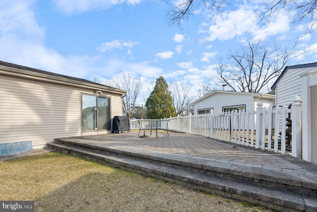 wooden terrace with a lawn, a grill, fence private yard, and a patio area