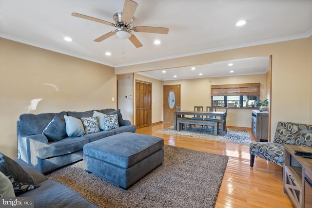 living room featuring recessed lighting, light wood-type flooring, ornamental molding, and ceiling fan