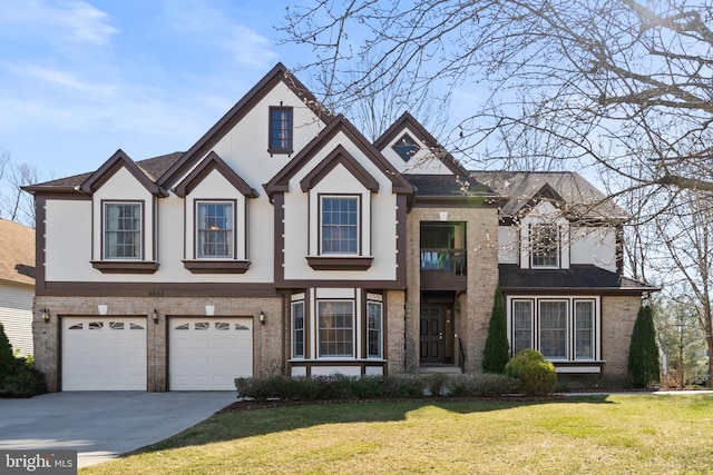 view of front of home featuring brick siding, stucco siding, driveway, and a front lawn