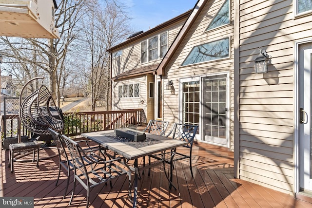 wooden terrace with outdoor dining space