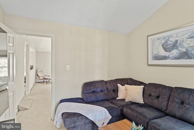 living area featuring lofted ceiling and light colored carpet