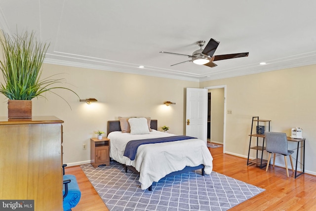 bedroom featuring recessed lighting, wood finished floors, baseboards, and ornamental molding