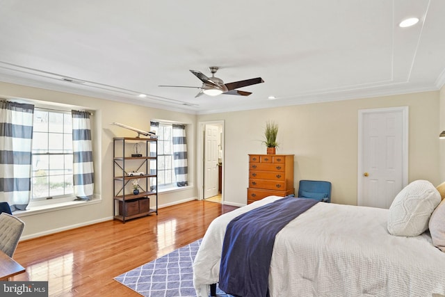 bedroom with recessed lighting, baseboards, wood finished floors, and ornamental molding