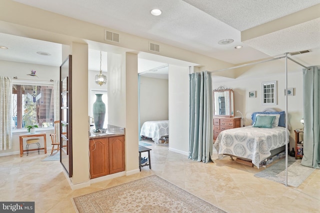 bedroom featuring recessed lighting, visible vents, and a textured ceiling