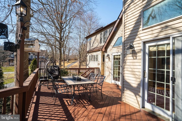 wooden deck featuring outdoor dining space