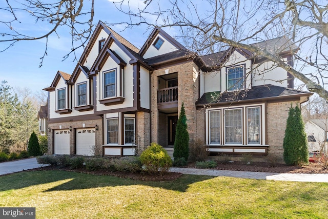 view of front of property with brick siding, stucco siding, an attached garage, and a front lawn