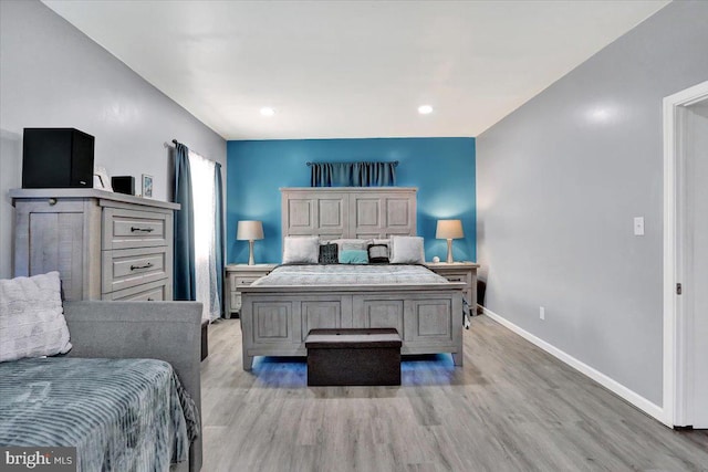 bedroom with baseboards and light wood-style floors