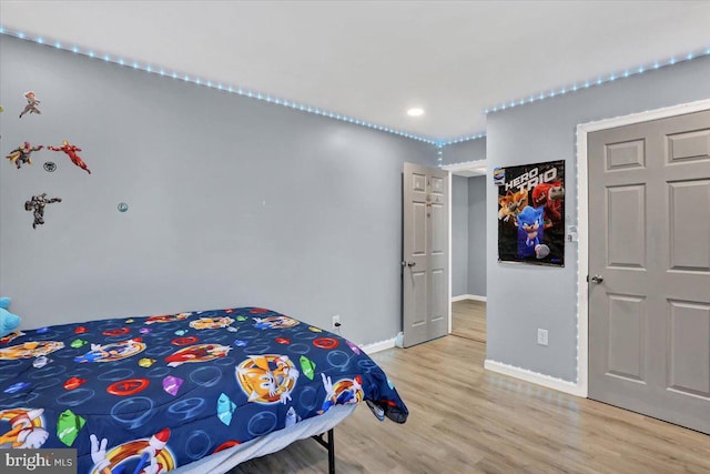 bedroom featuring light wood-type flooring and baseboards