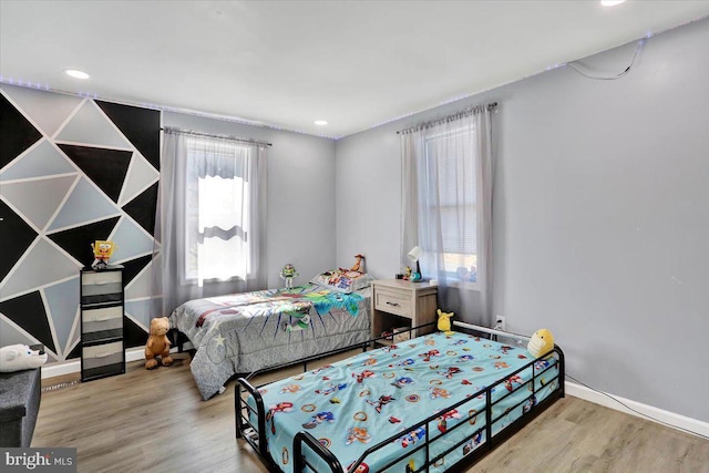 bedroom with recessed lighting, baseboards, and wood finished floors