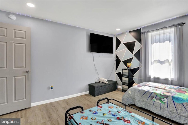 bedroom with recessed lighting, wood finished floors, and baseboards