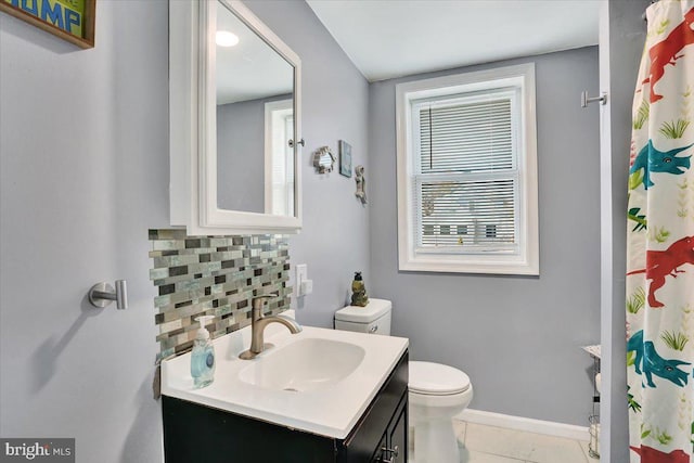 full bath featuring tasteful backsplash, baseboards, toilet, tile patterned floors, and vanity