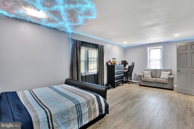 bedroom featuring baseboards and wood finished floors