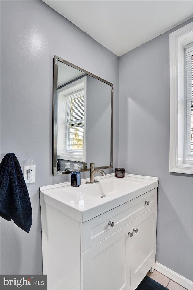 bathroom with vanity and baseboards