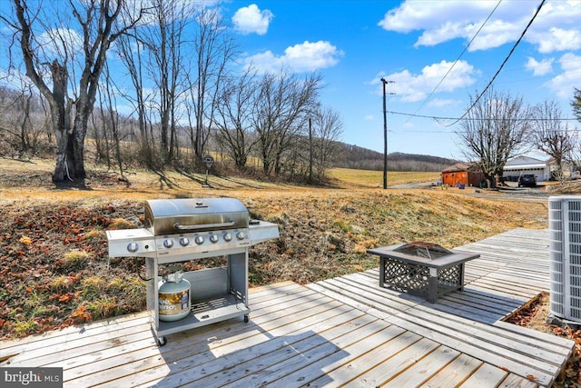 deck with cooling unit, area for grilling, and an outdoor fire pit