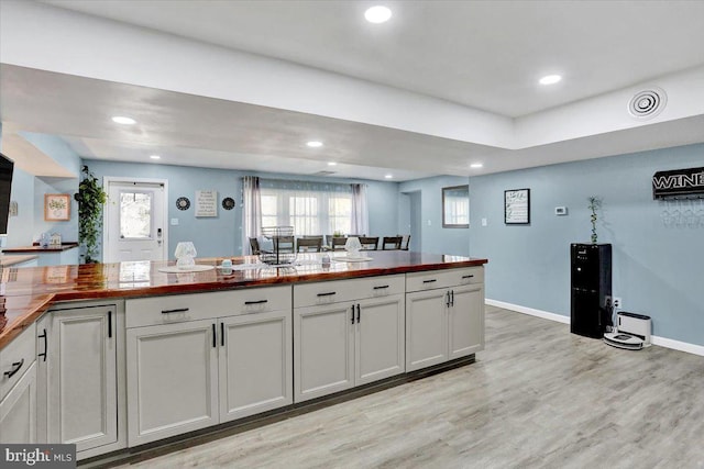 kitchen with visible vents, baseboards, butcher block counters, light wood-type flooring, and recessed lighting