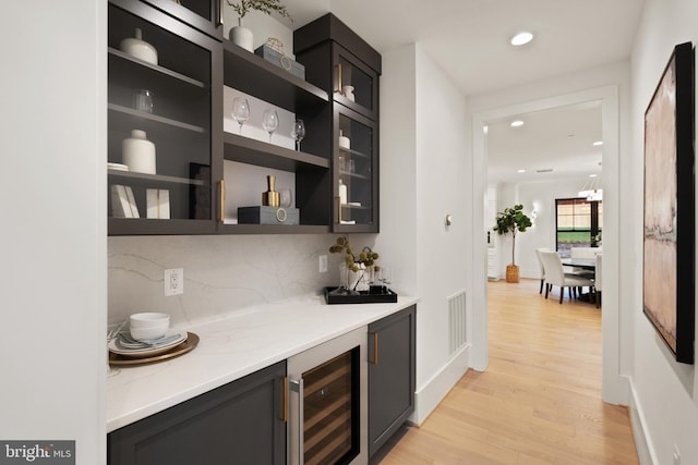 bar with visible vents, light wood-style flooring, recessed lighting, decorative backsplash, and wine cooler