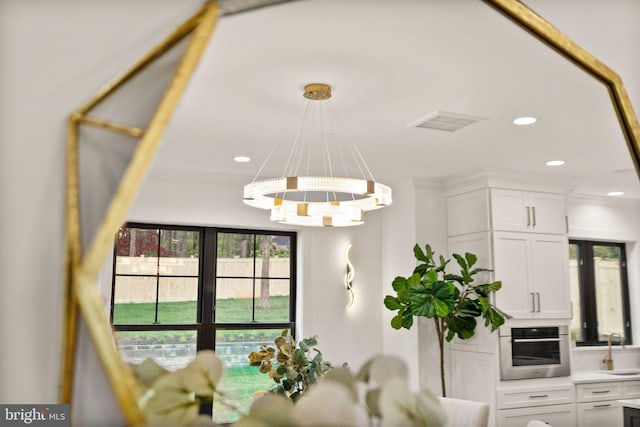 dining room featuring recessed lighting, visible vents, and crown molding