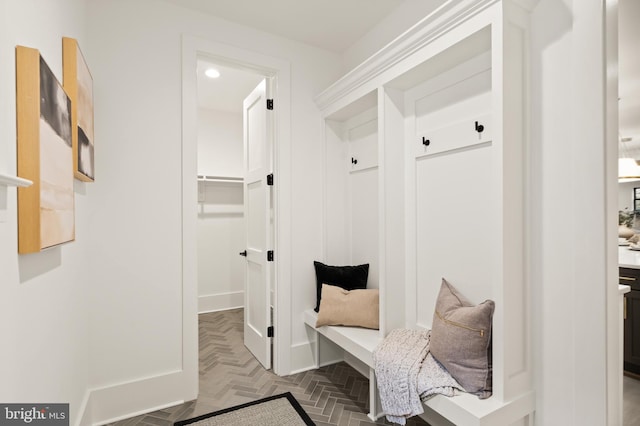 mudroom with recessed lighting and baseboards