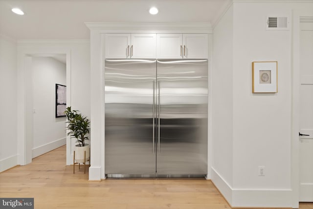 kitchen featuring visible vents, built in refrigerator, recessed lighting, light wood-style floors, and white cabinetry