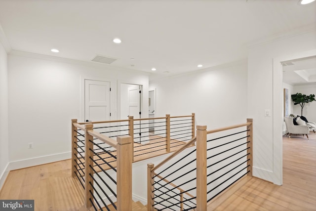 corridor with an upstairs landing, visible vents, recessed lighting, and wood finished floors