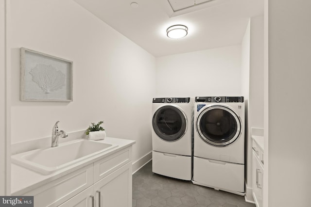 laundry room with light tile patterned floors, cabinet space, independent washer and dryer, and a sink