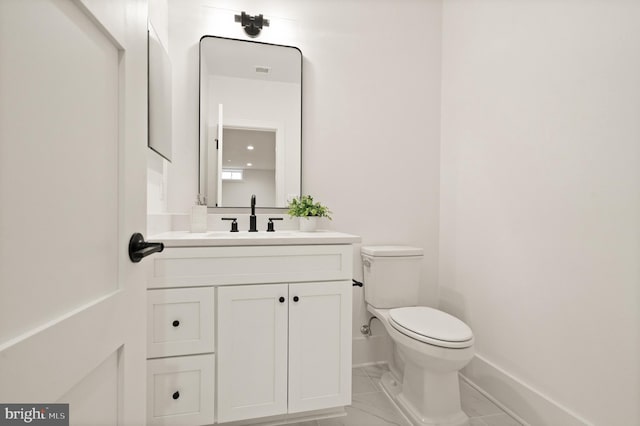 half bath featuring baseboards, toilet, marble finish floor, and vanity