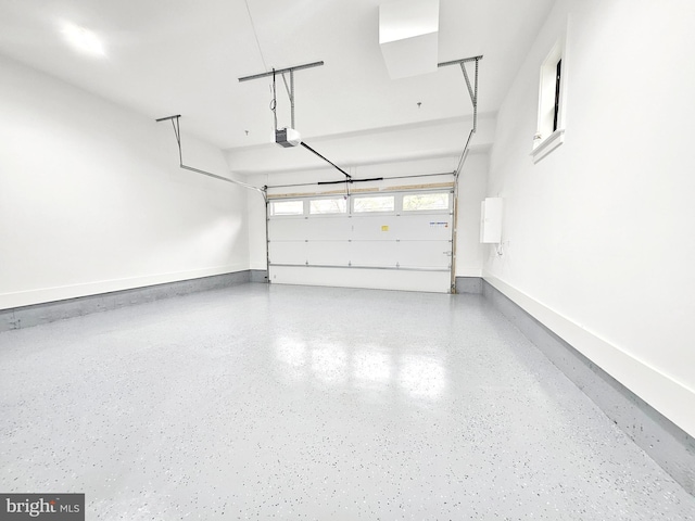 garage with baseboards and a garage door opener