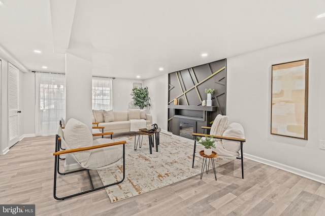 living room featuring recessed lighting, baseboards, and wood finished floors