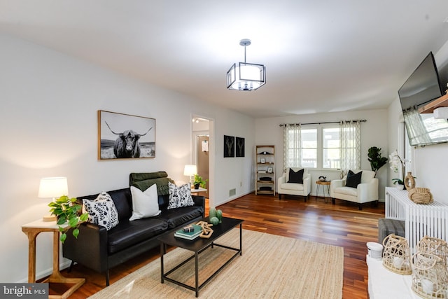 living area featuring baseboards and wood finished floors