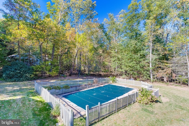 view of swimming pool featuring a fenced in pool, a yard, and fence