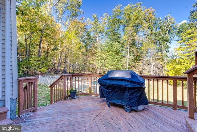 wooden deck featuring a grill