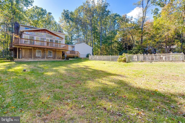 view of yard with a deck and fence