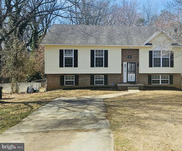 raised ranch with brick siding and fence