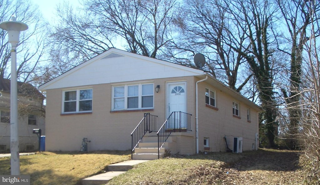 bungalow-style home featuring brick siding