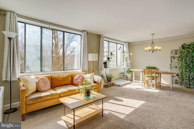 living area featuring a notable chandelier and carpet