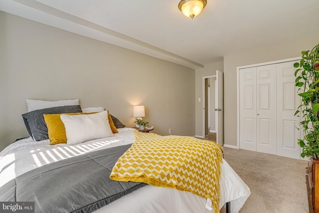 bedroom featuring baseboards, a closet, and carpet floors