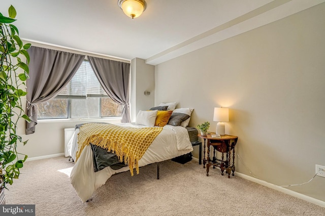 carpeted bedroom featuring baseboards