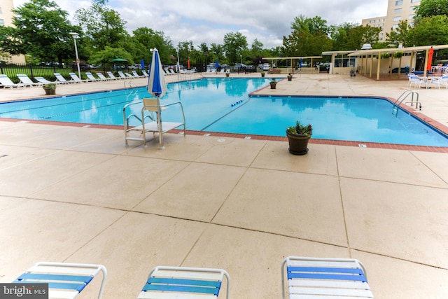 pool featuring a patio and fence