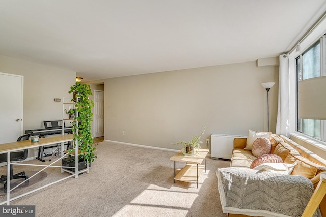 carpeted living area featuring radiator heating unit and baseboards