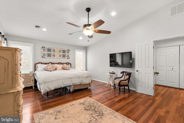 bedroom with visible vents, dark wood-type flooring, baseboards, and vaulted ceiling