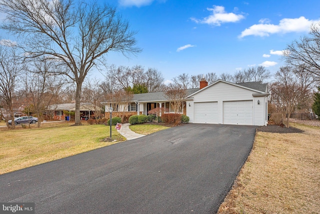 ranch-style house with a front lawn, a garage, driveway, and a chimney