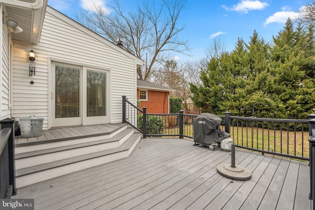 wooden deck with a grill