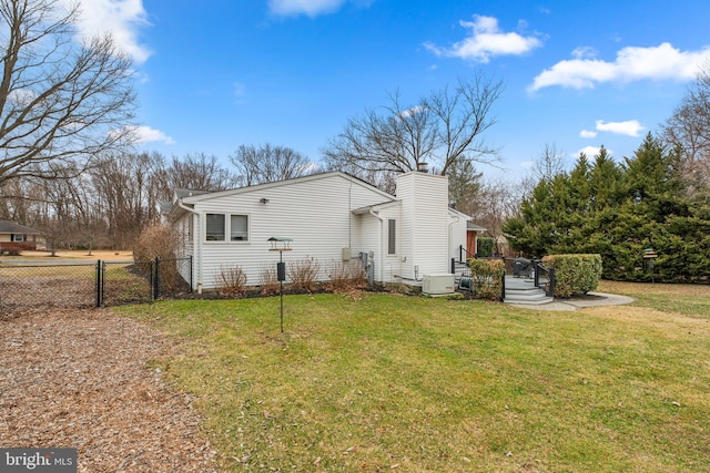 view of property exterior with a gate, fence, a lawn, and a chimney