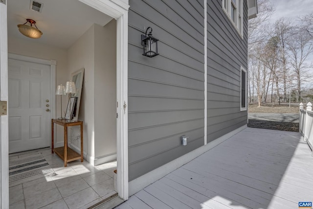 wooden deck featuring visible vents